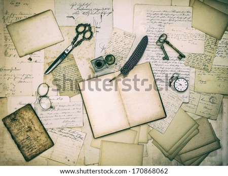 antique accessories, old letters and vintage ink pen. nostalgic sentimental paper background toned and textured