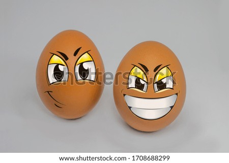 Close up on eggs with cartoon face isolated on white background.
