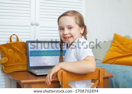 Curious child using laptop at home. Distance learning, hobby and leisure activity concept