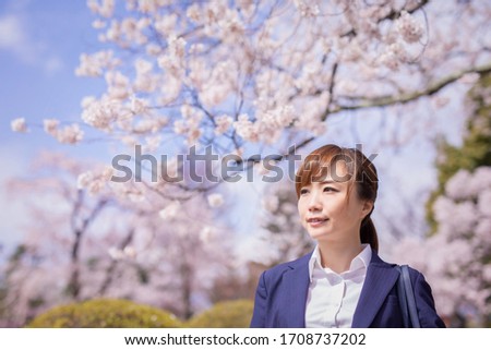 A cherry tree and Asian office worker