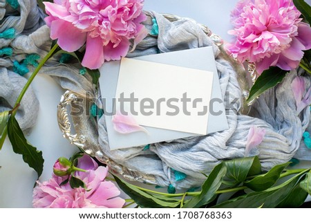 proposal ring in box. ribbon and pink  flower. peony and green leaves. valentine's day. wed invitation card