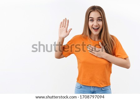 I swear, promise you not regret. Portrait of happy, sincere blonde girl raising one arm and hold hand on heart as give oath, pledge, telling truth, want you to believe, standing white background Royalty-Free Stock Photo #1708797094