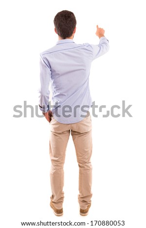 A young man with his back turned to camera, pointing to something Royalty-Free Stock Photo #170880053