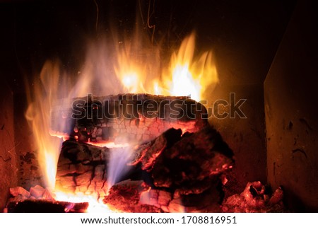Warm bonfire made up of large pieces of burning wood