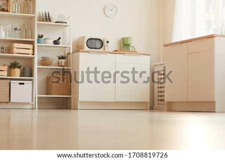 Warm toned low angle of contemporary kitchen interior with minimal design and wooden elements, copy space Royalty-Free Stock Photo #1708819726