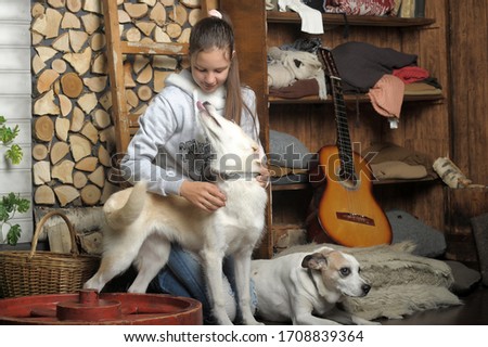 Teenage girl hugging her dog.