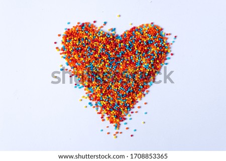 bigger bright colored heart made of colorful balls on a white background Defocus. Bokeh with place for your text.