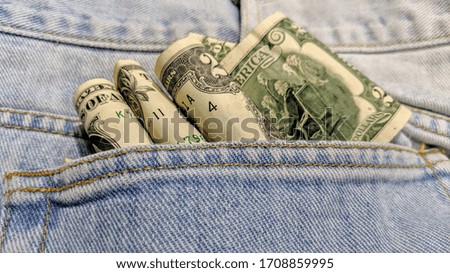 USD money in the pocket of jeans. The concept of finance. Selective focus. Close-up. Copy space.