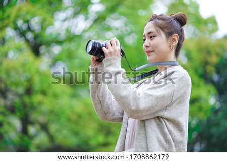 Asian woman going out with a camera
