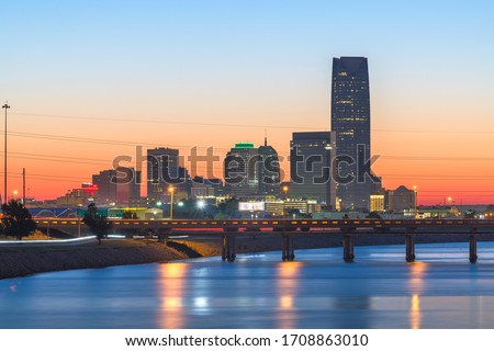Oklahoma City, Oklahoma, USA downtown skyline on the Oklahoma River at dusk.
