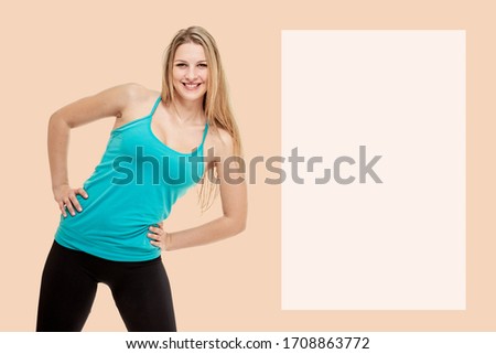 Beautiful slim sporty woman training on peach background