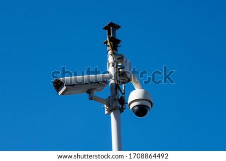 Security camera's outside with blue sky backdrop