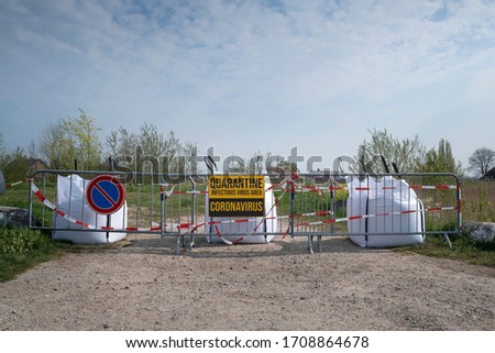 Concept of coronavirus quarantine. Coronavirus written on stop sign on the control barrier at the entrance to a infectious place. blocked roadway, control