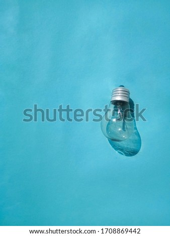 minimalist photo of a neon lamp with a blue background