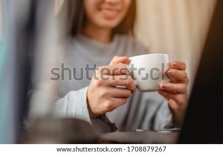Woman holding a coffee cup work from home wait epidemic situation to improve soon at home. Coronavirus, covid-19, Work from home (WFH), Social distancing, Quarantine, Prevent infection concept. Royalty-Free Stock Photo #1708879267