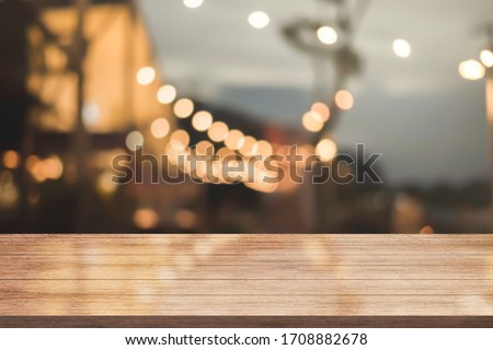 Empty wooden table top with lights bokeh on blur restaurant background. Royalty-Free Stock Photo #1708882678