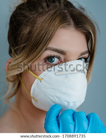 MERTHYR TYDFIL, WALES - 19 APRIL 2020 - Lady model shown wearing her personal protective equipment.  Face mask & surgical gloves during covid-19 epidemic.