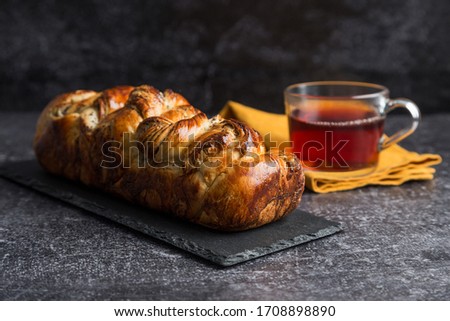 Sweet roll cake with poppy seeds with cup of tea. Concept of dessert for holiday. Concept of dessert picture with free space.
