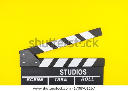 Movie clapper isolated on yellow background.