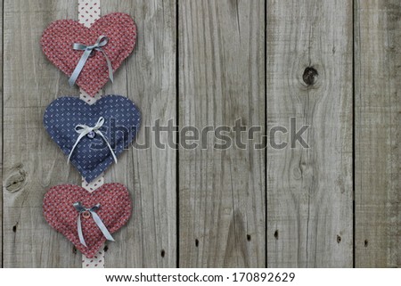 Pink and blue calico hearts border on wood background