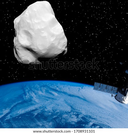 Asteroid above the earth. Elements of this image furnished by NASA.
