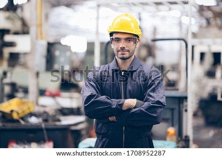 profession technician engineer arms cross and standing in factory Royalty-Free Stock Photo #1708952287