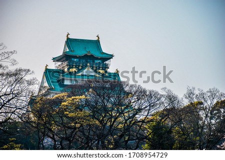 Beautiful blue Osaka castle above the secon largest city in Japan