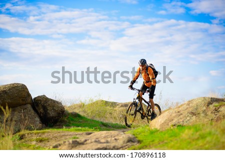 Cyclist Riding the Bike on the Beautiful Spring Mountain Trail