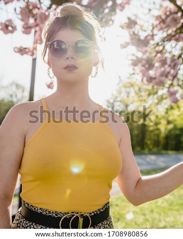 MERTHYR TYDFIL, WALES - 19 APRIL 2020 - Blonde lady stops to pose while out for her daily allowed exercise during the covid-19 U.K. lockdown.