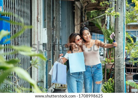 Two young woman vlogging or recording video outdoors stock photo.  Female blogger recording video with smartphone, making vlog, new in haul or blog