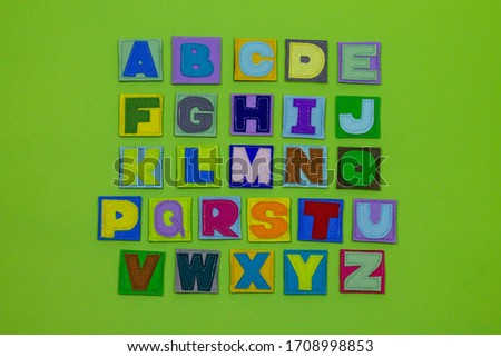 Alphabet. All letters of the alphabet in one place. Multicolored, beautiful letters. ABC. Occupation with children. Learning letters. English. Green background