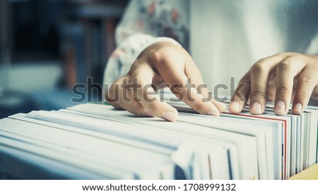 Businesswoman hands working in Stacks of paper files for searching information on work desk office, business report papers,piles of unfinished documents achieves with clips indoor,Business concept