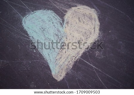 
Colorful heart chalk drawing - drawn by a child on a pedestrian pavement, asphalt