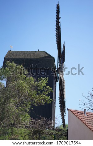 Historical old wooden windmill against blue sky in Werder, Brandenburg, Germany                             