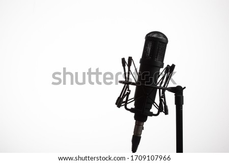 Studio microphone on a rack. Vocal microphone photographed on an isolated white background.