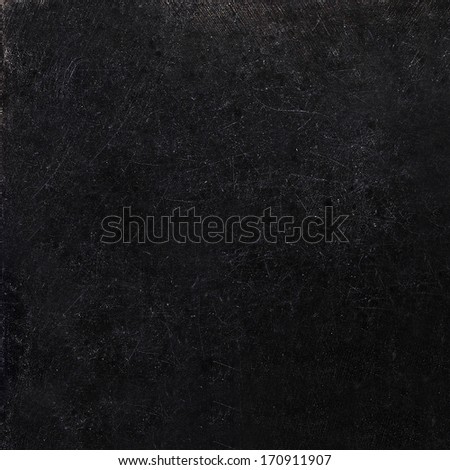 Abstract black background with scratches. Vintage grunge background texture, elegant monochrome background design. Grungy textured blackboard.