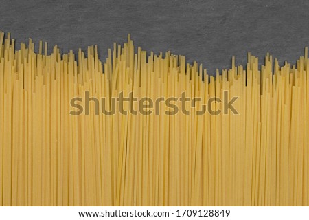 Spaghetti on stone slate background.