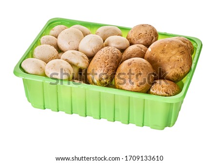 Champignon mushrooms in packing, white isolated background with clipping path                                       