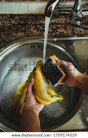 Disinfect the purchase. Woman cleaning food to prevent the spread of the COVID-19 virus.