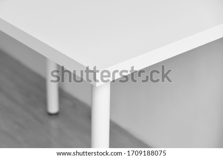 Table corner, Sharp desk edge, Home accident from furniture, White table with hard angle, Minimal style and copyspcae for wording. Royalty-Free Stock Photo #1709188075