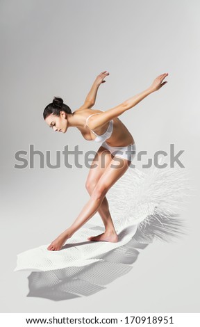 bending healthy woman on white feather