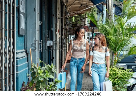 Two beautiful young women enjoying shopping in the city stock photo
