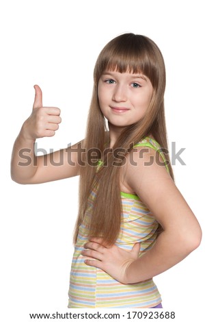A profile portrait of a pretty preteen girl holding her thumb up