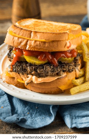 Unhealthy Grilled Cheese Hamburger with Fries and Pickles