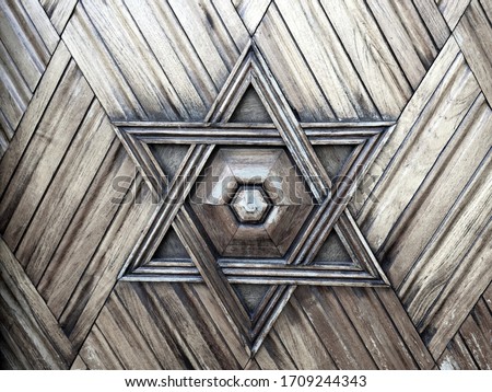 Star of David on the wooden door of a synagogue. Also known as Shield of David or Magen David it is a recognized symbol of Judaism.