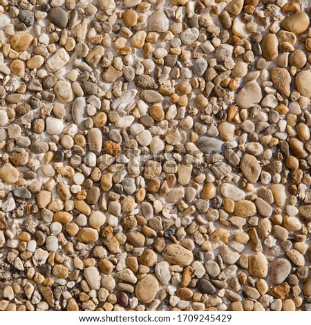 Abstract Grunge Background from small stones. Decorative pattern of natural stone for wall and floor decoration. Square Rough Surface Texture for design