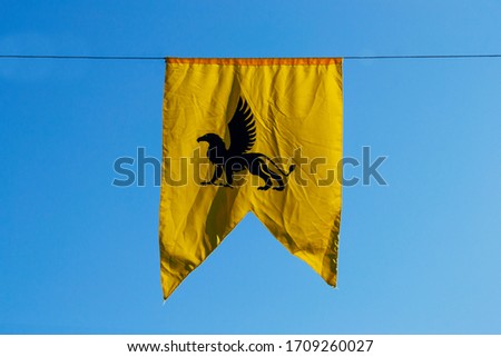 yellow chimera banner with blue sky in the background. Medieval concept