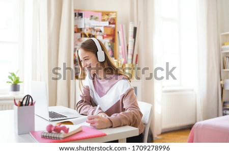 Young female student sitting at the table, using laptop when studying. Royalty-Free Stock Photo #1709278996