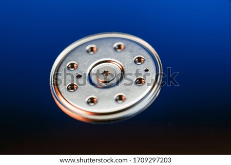 center of the hard drive, background, the image of inside of hard disk drive on the technician's desk and a computer motherboard, toned