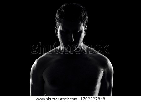 Silhouette of a young man. Photo in black. Dramatic light. Face and shoulders in first photograph with side lights.